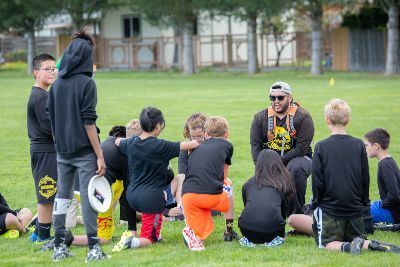A coach working with young players on the field