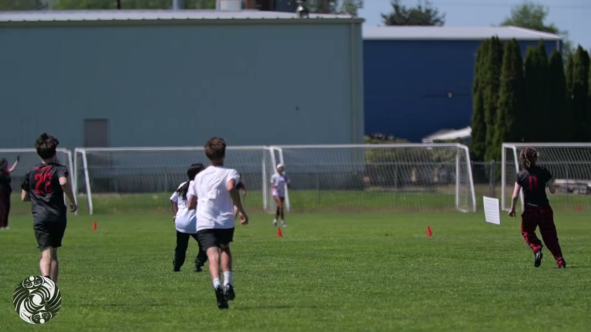 Players chasing down a long throw on an open field