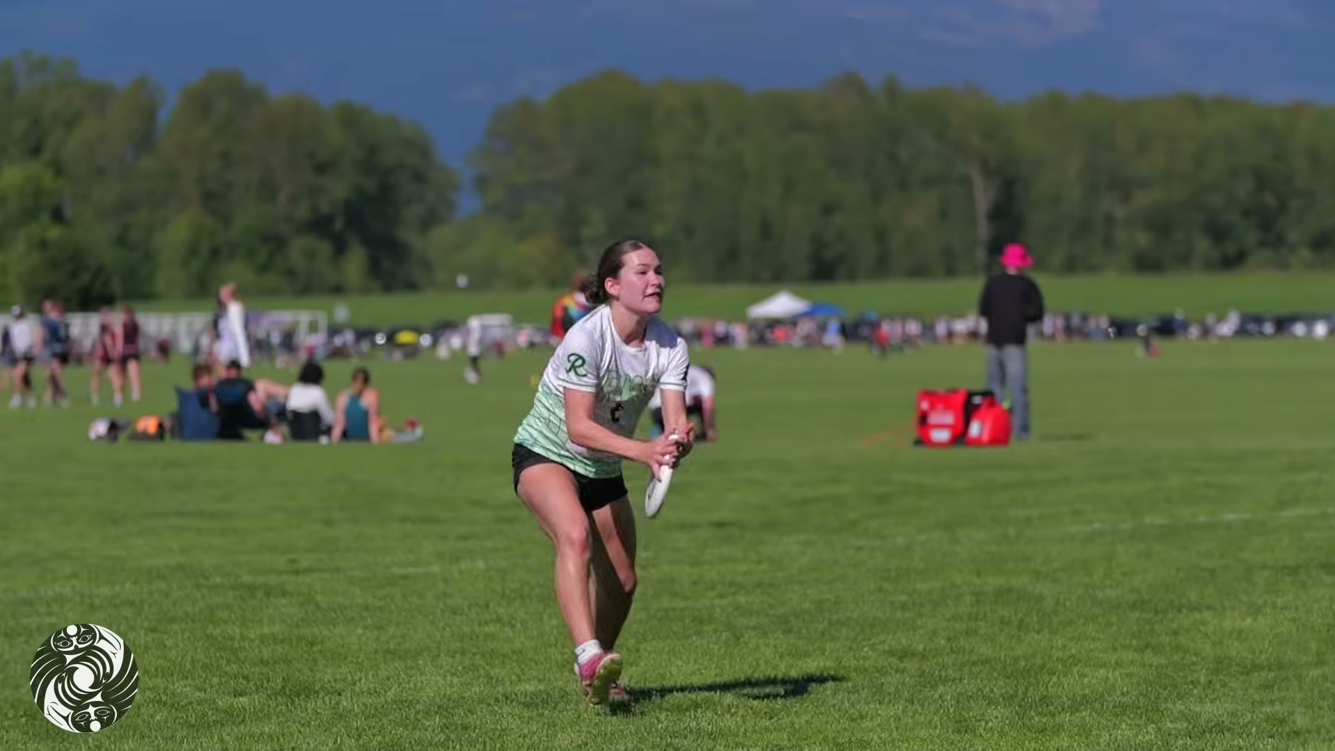A player throwing a disc with mountains in the distance
